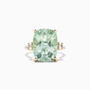The 14K Yellow Gold Green Amethyst and Diamond Cocktail Ring (10.51 TCW) showcases a striking rectangular green amethyst center, accented by small diamonds on each side, set against a white background.