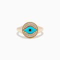 The Terra 14K Yellow Gold Turquoise and Diamond Evil Eye Ring features an eye-shaped motif with a turquoise center, a black pupil, and a border of sparkling diamonds surrounding the design.