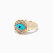 The Terra 14K Yellow Gold Turquoise and Diamond Evil Eye Ring features an eye-shaped motif with a turquoise center, a black pupil, and a border of sparkling diamonds surrounding the design.
