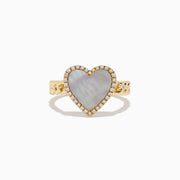The Novelty 14K Yellow Gold Mother of Pearl and Diamond Heart Ring features a heart-shaped mother-of-pearl center, diamond accents, and a textured band, displayed on a white background.