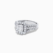 The 14K White Gold Diamond Ring, 2.00 TCW features a square-cut center diamond with a sparkling halo and triple diamond-encrusted band, beautifully showcased against a plain white background.