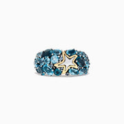 The Seaside Silver and 18K Gold Blue Topaz Starfish Ring, 6.70 TCW, features clusters of oval blue topaz stones set in silver with a gold-outlined starfish accent at the center, shown on a white background.