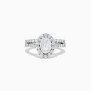The 14K White Gold Diamond Ring and Matching Band Set, 2.00 TCW, features a large oval center diamond with a halo of round diamonds and a diamond-studded band—displayed against white, ideal for elegant bridal sets.