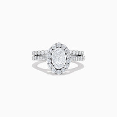 The 14K White Gold Diamond Ring and Matching Band Set, 2.00 TCW, features a large oval center diamond with a halo of round diamonds and a diamond-studded band—displayed against white, ideal for elegant bridal sets.