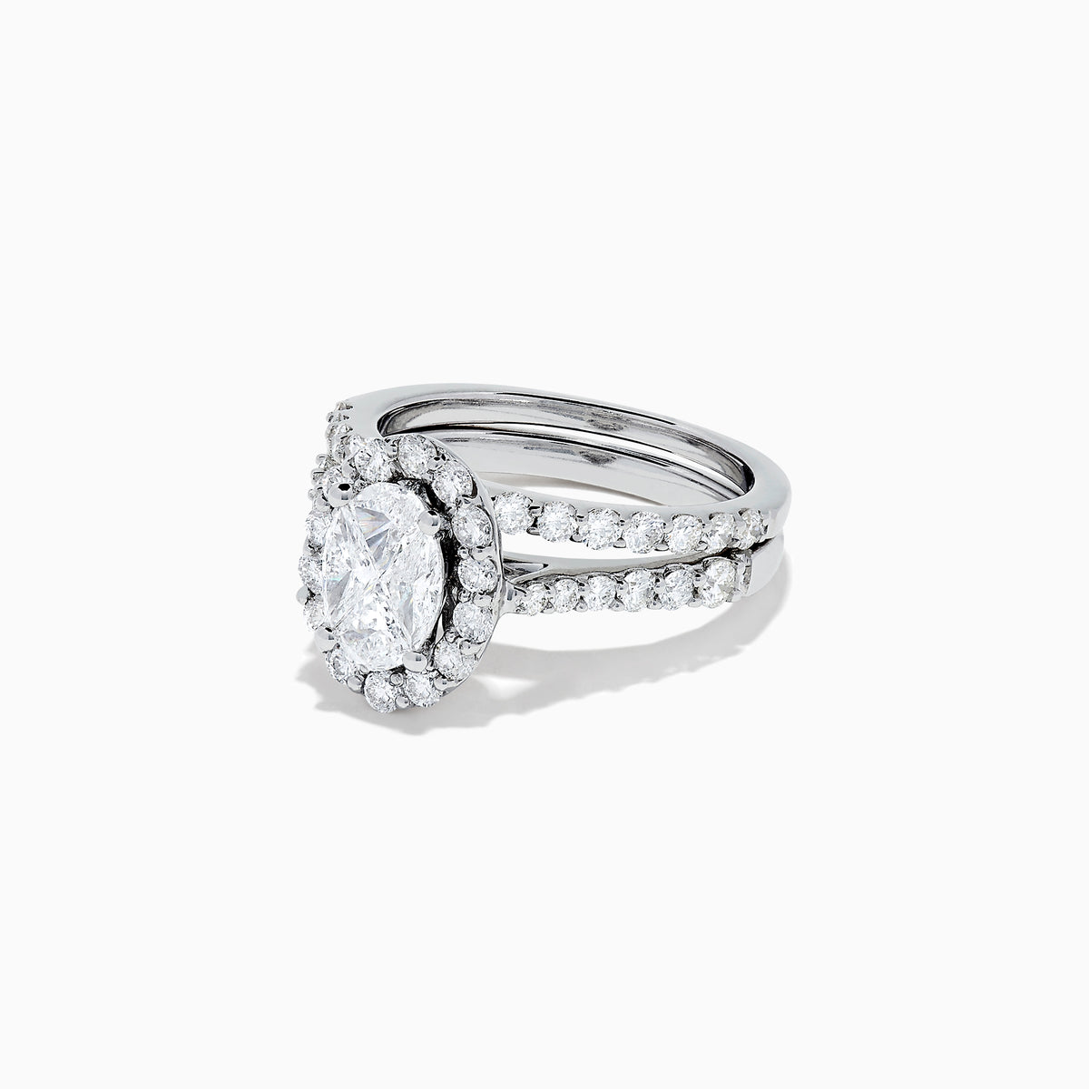 The 14K White Gold Diamond Ring and Matching Band Set, 2.00 TCW, features a large oval center diamond with a halo of round diamonds and a diamond-studded band—displayed against white, ideal for elegant bridal sets.