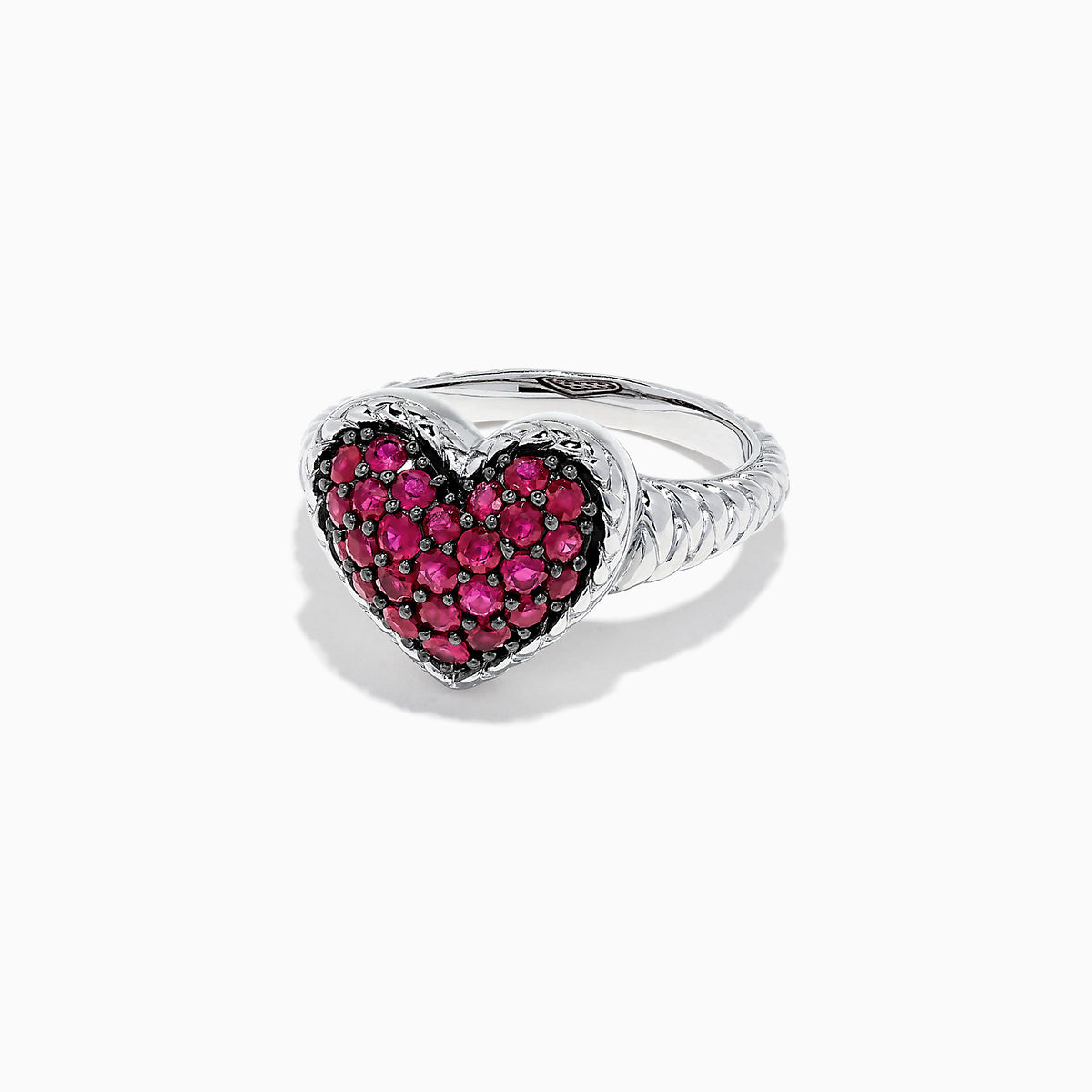 The 925 Sterling Silver Ruby Heart Ring, 1.02 TCW, showcases a heart-shaped centerpiece adorned with sparkling red stones set in silver against a white backdrop.