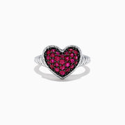 The 925 Sterling Silver Ruby Heart Ring, 1.02 TCW, showcases a heart-shaped centerpiece adorned with sparkling red stones set in silver against a white backdrop.
