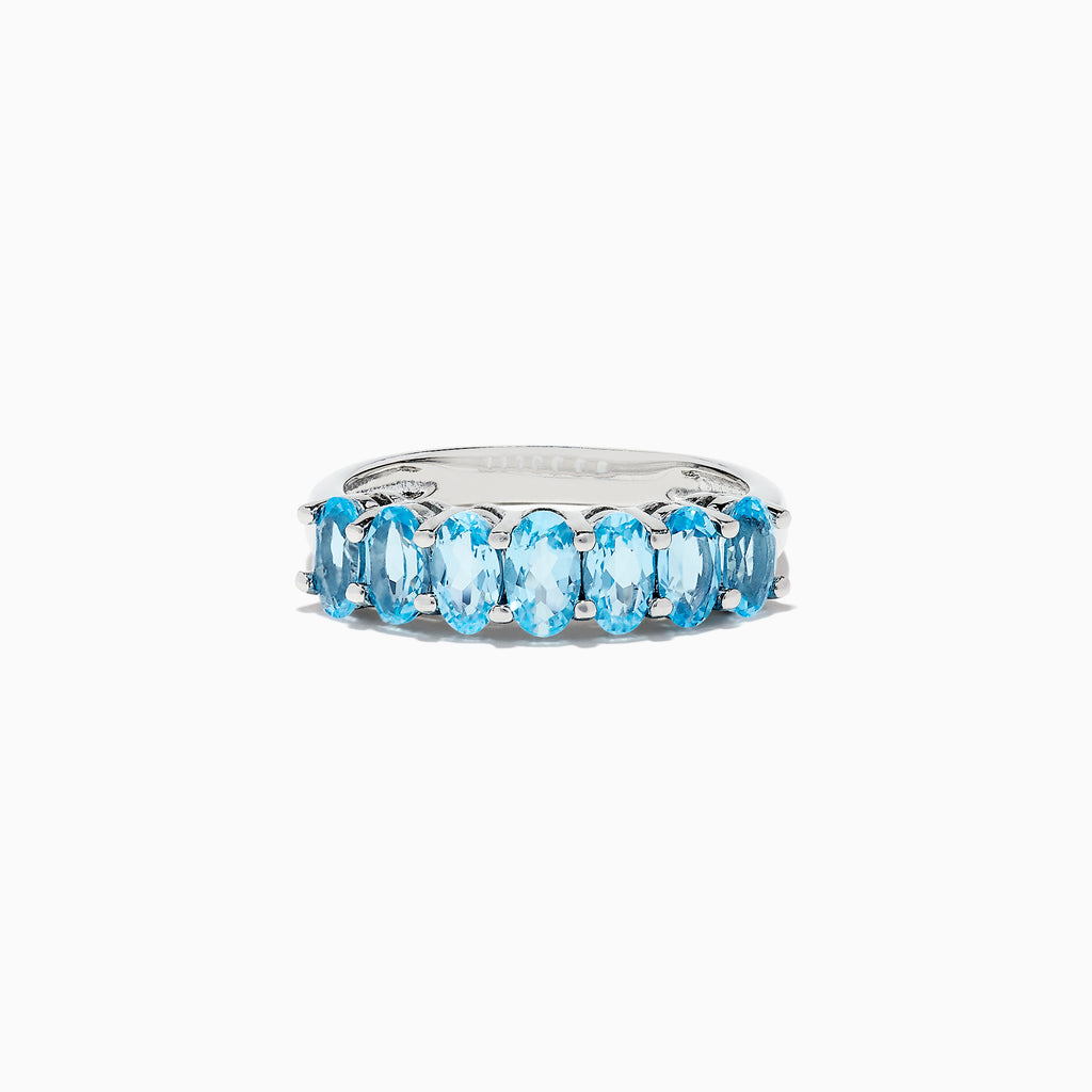 A dazzling 925 Sterling Silver Blue Topaz Ring, 1.95 TCW, showcases seven oval-cut blue topaz stones in prong settings against a white background.