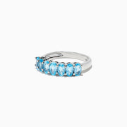 A dazzling 925 Sterling Silver Blue Topaz Ring, 1.95 TCW, showcases seven oval-cut blue topaz stones in prong settings against a white background.
