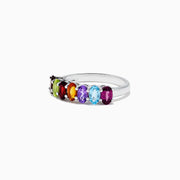The Mosaic Sterling Silver Multi Gemstone Ring, 1.66 TCW, features a row of vibrant oval-shaped gems in red, green, orange, purple, blue, and brown set side by side across the band.