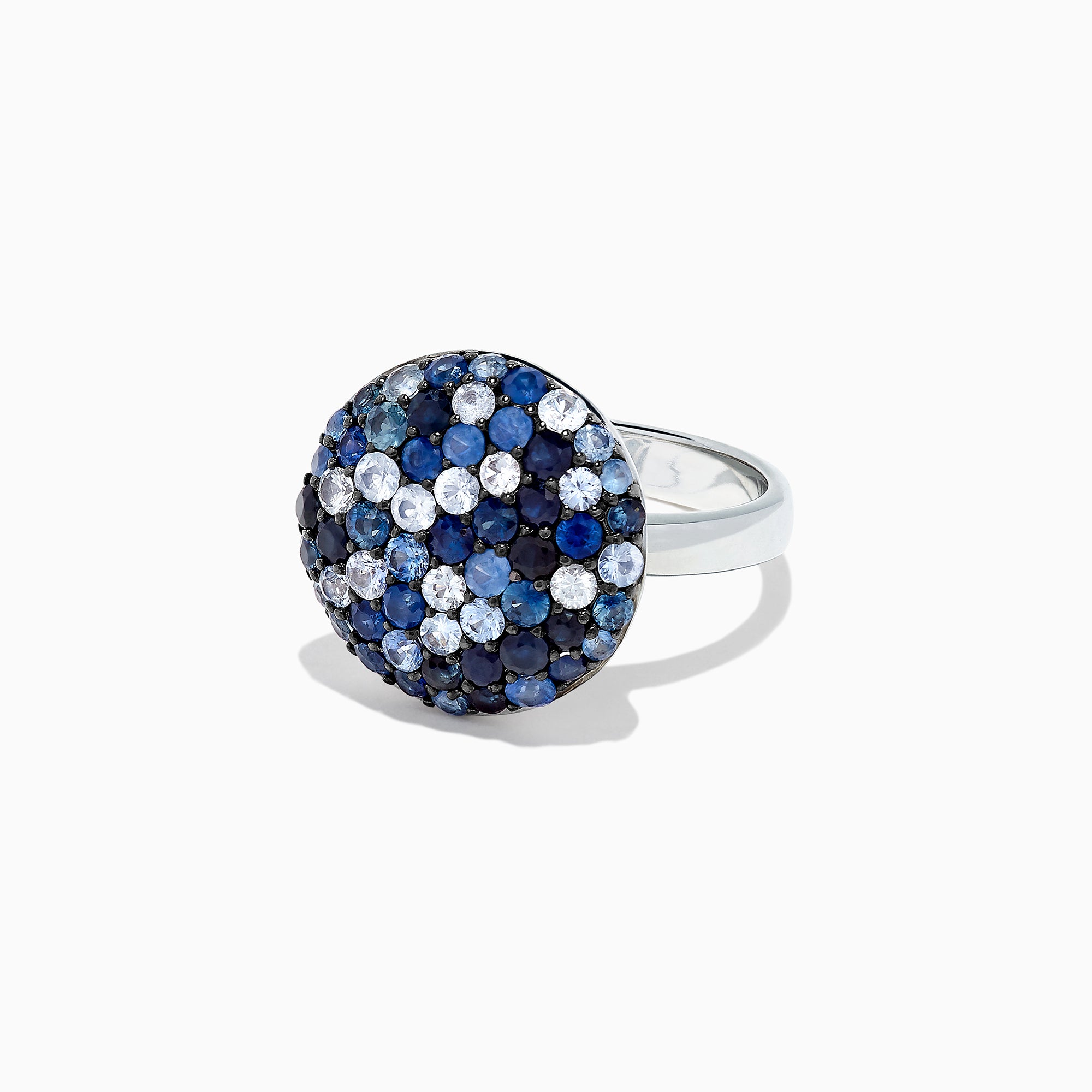 The Splash Sterling Silver Blue Sapphire Circle Ring, 2.95 TCW, features a round design with a domed top adorned with blue sapphires and white gemstones in a bold checkered pattern.