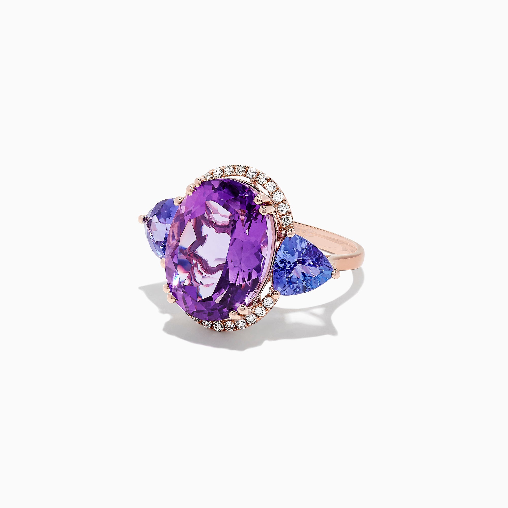 The 14K Rose Gold Amethyst, Tanzanite and Diamond Ring, 10.28 TCW features a striking amethyst center, accented by tanzanites and surrounded by a sparkling diamond halo.