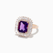 The 14K Rose Gold Amethyst and Diamond Cocktail Ring features a large rectangular amethyst center, encircled by two rows of sparkling white baguette and round diamonds in a dazzling halo setting.
