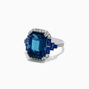 The 14K White Gold London Blue Topaz and Diamond Ring, 9.47 TCW, features a large rectangular London Blue Topaz with diamond accents and blue stones on the sides, shown from the front against a white background.
