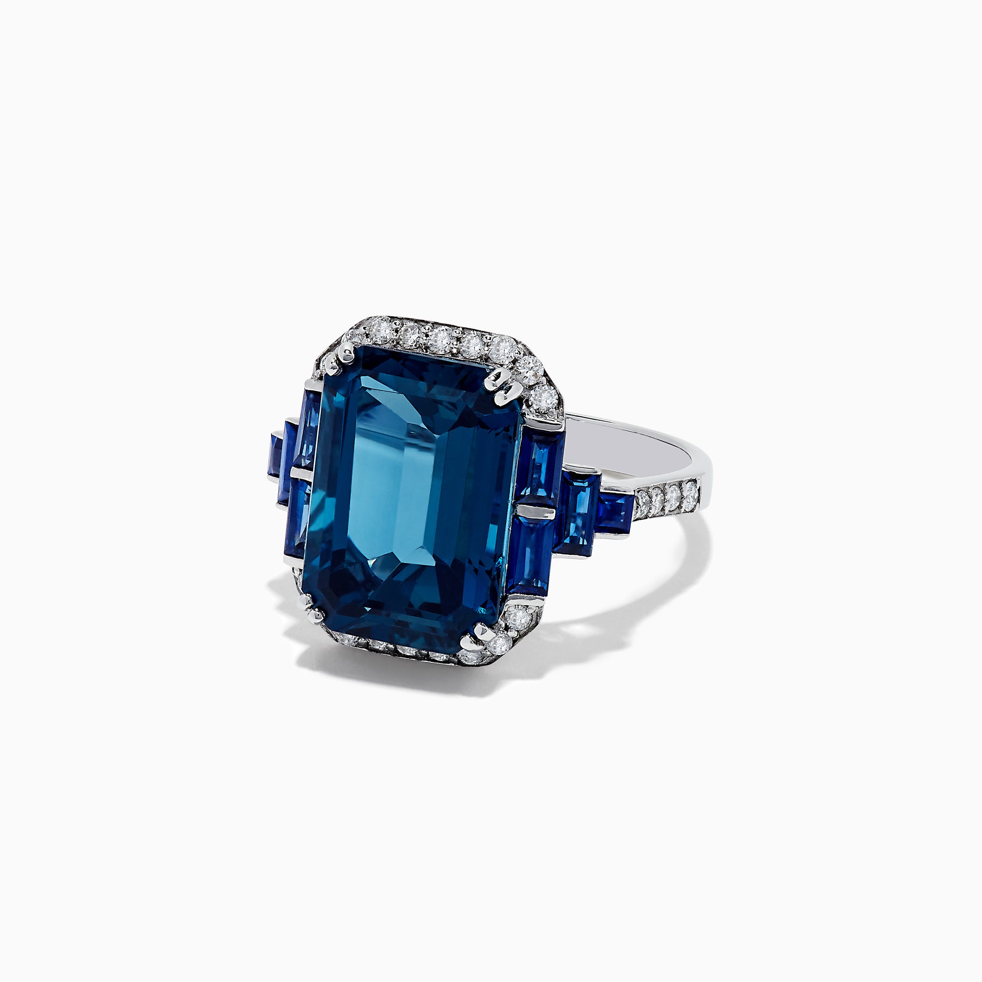 The 14K White Gold London Blue Topaz and Diamond Ring, 9.47 TCW, features a large rectangular London Blue Topaz with diamond accents and blue stones on the sides, shown from the front against a white background.