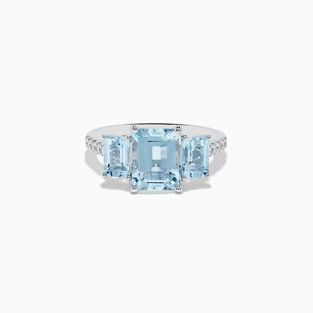The Aquarius 14K White Gold Diamond and Aquamarine Ring features a prominent emerald-cut aquamarine centerpiece, flanked by two rectangular blue stones and a band adorned with sparkling diamonds.