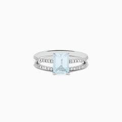 The Aquarius 14K Gold Aquamarine and Diamond Ring Set features a rectangular aquamarine centerpiece with two diamond-accented bands, shown against a plain white background.