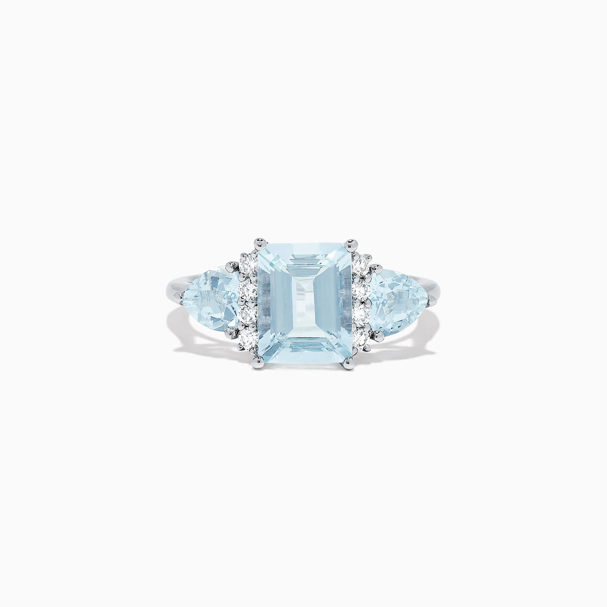 The Aquarius 14K White Gold Aquamarine and Diamond Ring, 3.30 TCW, showcases a large emerald-cut aquamarine center stone with two triangular blue side stones and sparkling round diamonds for added brilliance.