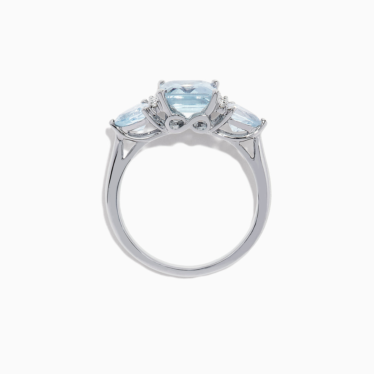 The Aquarius 14K White Gold Aquamarine and Diamond Ring, 3.30 TCW, showcases a large emerald-cut aquamarine center stone with two triangular blue side stones and sparkling round diamonds for added brilliance.