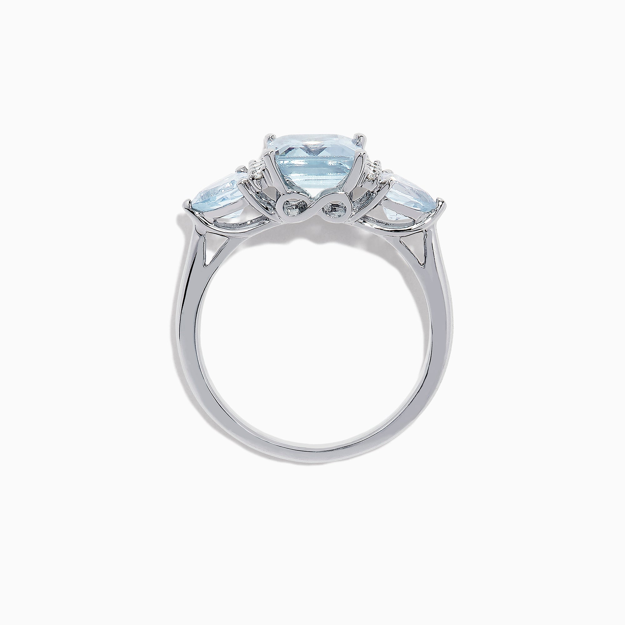 The Aquarius 14K White Gold Aquamarine and Diamond Ring, 3.30 TCW, showcases a large emerald-cut aquamarine center stone with two triangular blue side stones and sparkling round diamonds for added brilliance.