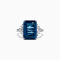 The Ocean Bleu 14K White Gold London Blue Topaz and Diamond Ring, 8.92 TCW, features a large rectangular blue topaz flanked by stepped baguette-cut diamonds, showcased on a white background.