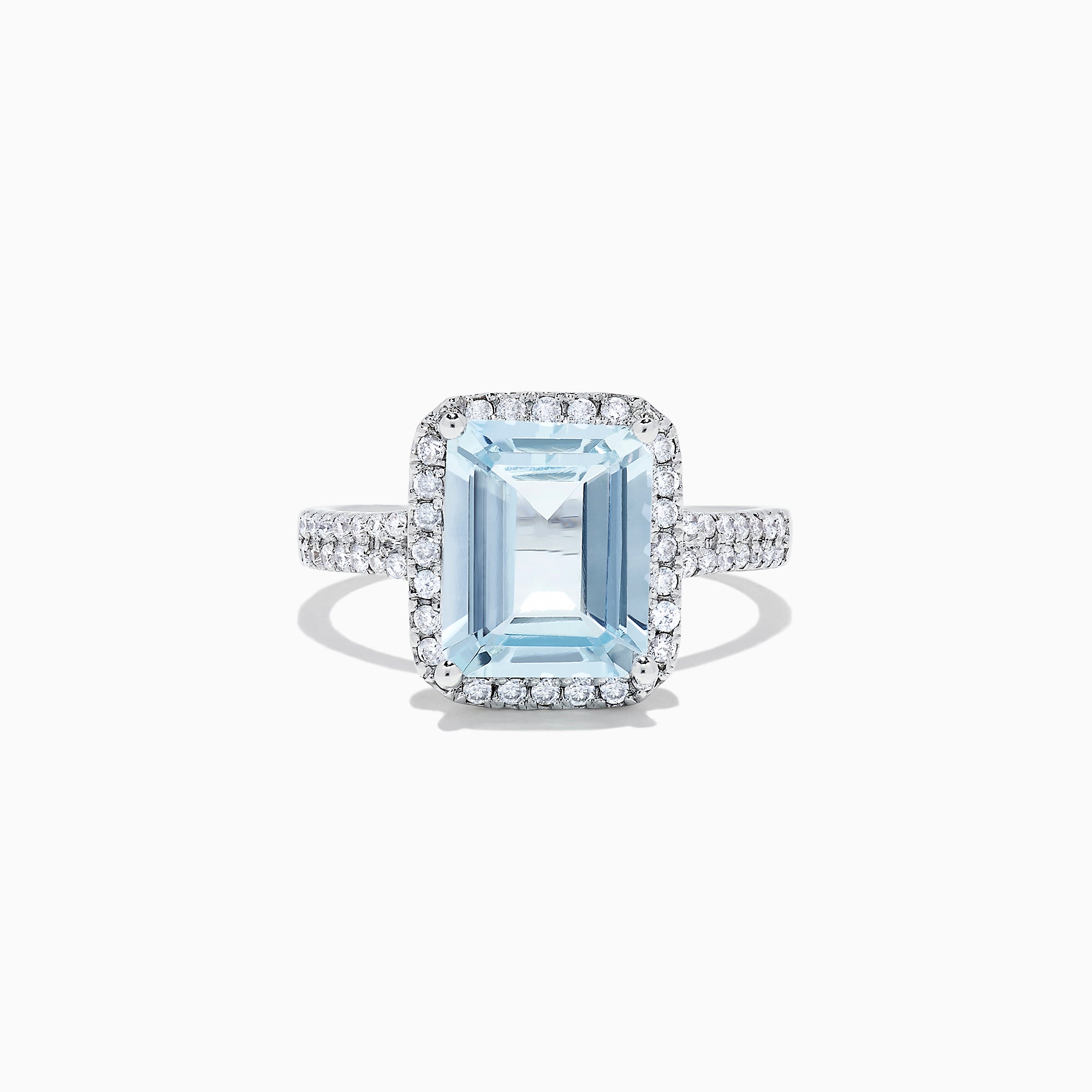 The Aquarius 14K White Gold Aquamarine and Diamond Ring, 3.33 TCW, features a large emerald-cut aquamarine surrounded by a diamond halo and set on a diamond-studded band, shown on a white background.
