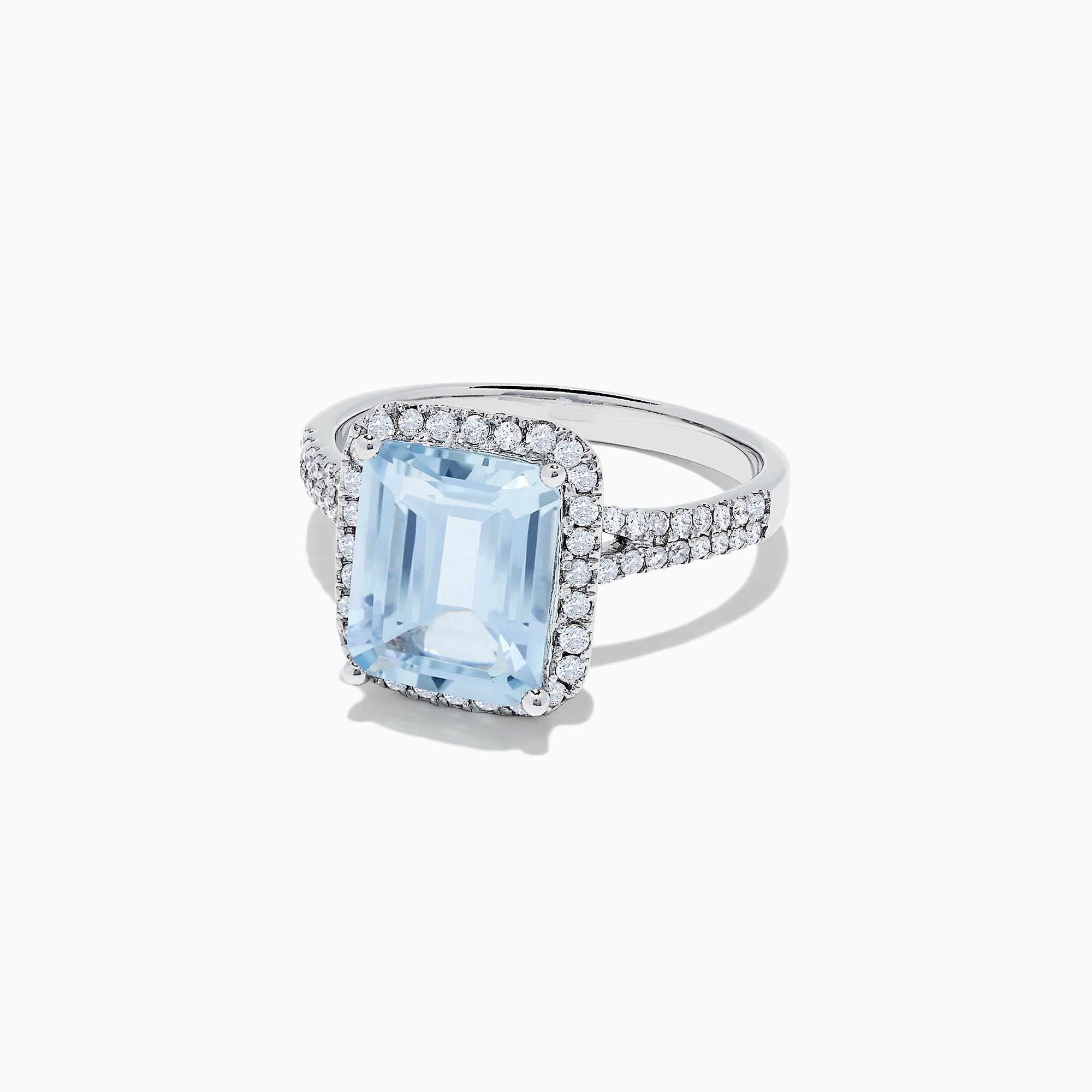 The Aquarius 14K White Gold Aquamarine and Diamond Ring, 3.33 TCW, features a large emerald-cut aquamarine surrounded by a diamond halo and set on a diamond-studded band, shown on a white background.