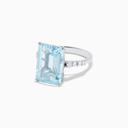 The Aquarius 14K White Gold Aquamarine and Diamond Cocktail Ring features a large rectangular aquamarine center stone flanked by round diamonds, all set in white gold and shown against a white background.