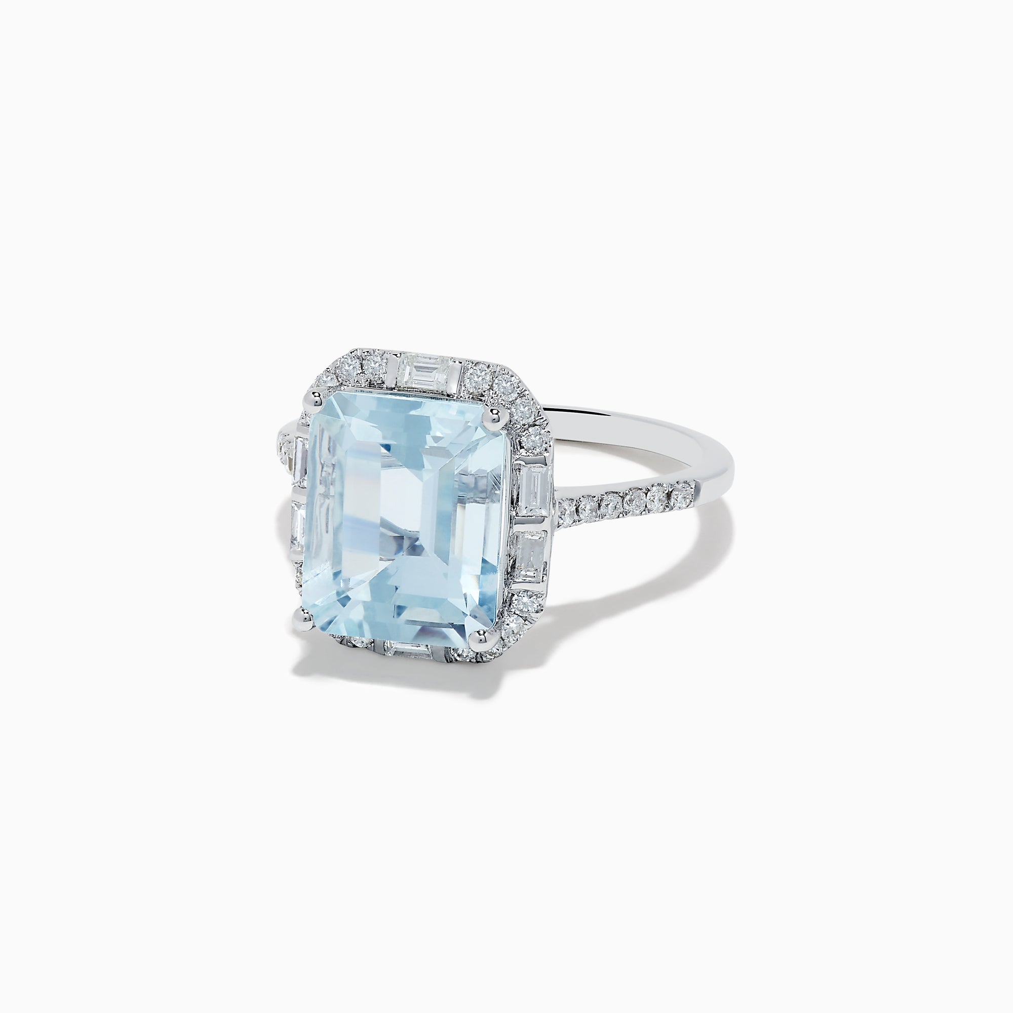 The Aquarius 14K White Gold Aquamarine and Diamond Ring showcases a large emerald-cut aquamarine center stone encircled by sparkling diamonds, presented against a white background.