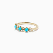The 14K Yellow Gold Turquoise and Diamond Ring, 0.39 TCW, features three turquoise stones and six small round diamonds set in an alternating pattern along the band.