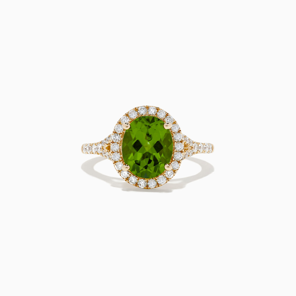 The 14K Yellow Gold Peridot and Diamond Ring showcases an oval-cut green peridot center, encircled by a halo of round white diamonds, with extra diamonds set along the band.