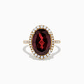 The Bordeaux 14K Yellow Gold Garnet and Diamond Cocktail Ring, 7.78 TCW, features a large oval deep red garnet encircled by a halo of sparkling diamonds, shown against a plain white background.