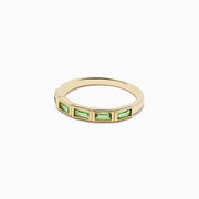 The 14K Yellow Gold Peridot Ring features a row of rectangular green peridot gemstones set around the band.