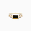 The 14K Yellow Gold Onyx Ring features a rectangular black onyx gemstone in the center, set on a polished yellow gold band with geometric side details.
