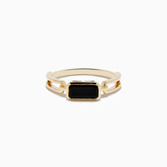 The 14K Yellow Gold Onyx Ring features a rectangular black onyx gemstone in the center, set on a polished yellow gold band with geometric side details.