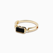 The 14K Yellow Gold Onyx Ring features a rectangular black onyx gemstone in the center, set on a polished yellow gold band with geometric side details.