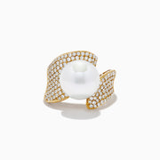 The 14K Yellow Gold Fresh Water Pearl and Diamond Statement Ring features a prominent pearl framed by two asymmetrical, diamond-studded gold bands, all set against a plain white background.