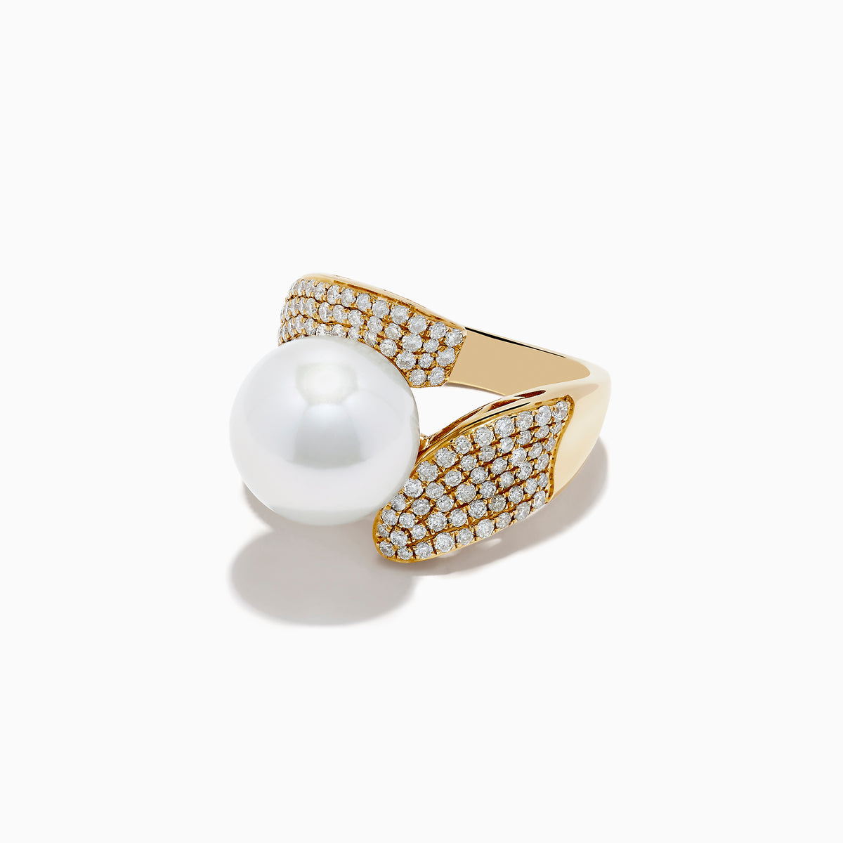 The 14K Yellow Gold Fresh Water Pearl and Diamond Statement Ring features a prominent pearl framed by two asymmetrical, diamond-studded gold bands, all set against a plain white background.