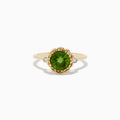 The 14K Yellow Gold Peridot and Diamond Ring showcases a round Peridot center stone with two small diamonds on each side, displayed against a white background.