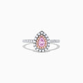 A teardrop-shaped 18K two tone gold ring features a GIA certified pink diamond (0.71 TCW) with a double halo of white and pink diamonds, set on a white diamond band, displayed against a white background.