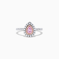 A teardrop-shaped 18K two tone gold ring features a GIA certified pink diamond (0.71 TCW) with a double halo of white and pink diamonds, set on a white diamond band, displayed against a white background.