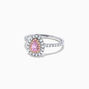 A teardrop-shaped 18K two tone gold ring features a GIA certified pink diamond (0.71 TCW) with a double halo of white and pink diamonds, set on a white diamond band, displayed against a white background.