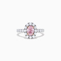 A GIA certified faint pink diamond ring, 1.53 TCW, set in a halo of round white diamonds on an 18K two tone gold band. Shown on a plain white background.