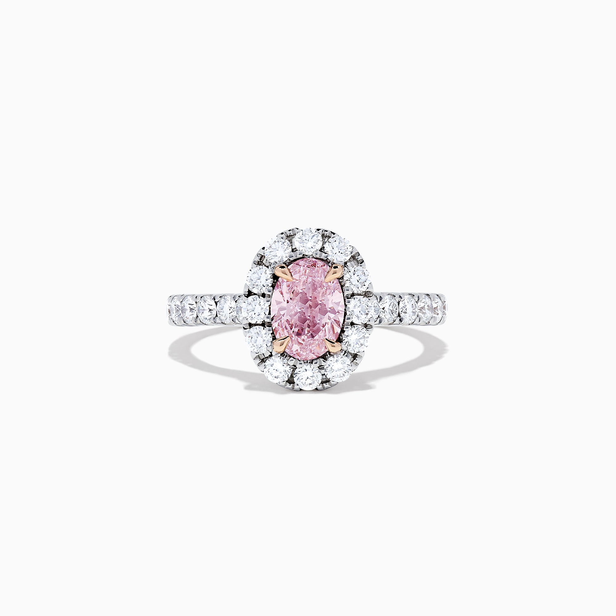 A GIA certified faint pink diamond ring, 1.53 TCW, set in a halo of round white diamonds on an 18K two tone gold band. Shown on a plain white background.