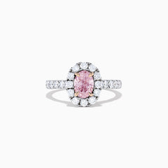 A GIA certified faint pink diamond ring, 1.53 TCW, set in a halo of round white diamonds on an 18K two tone gold band. Shown on a plain white background.