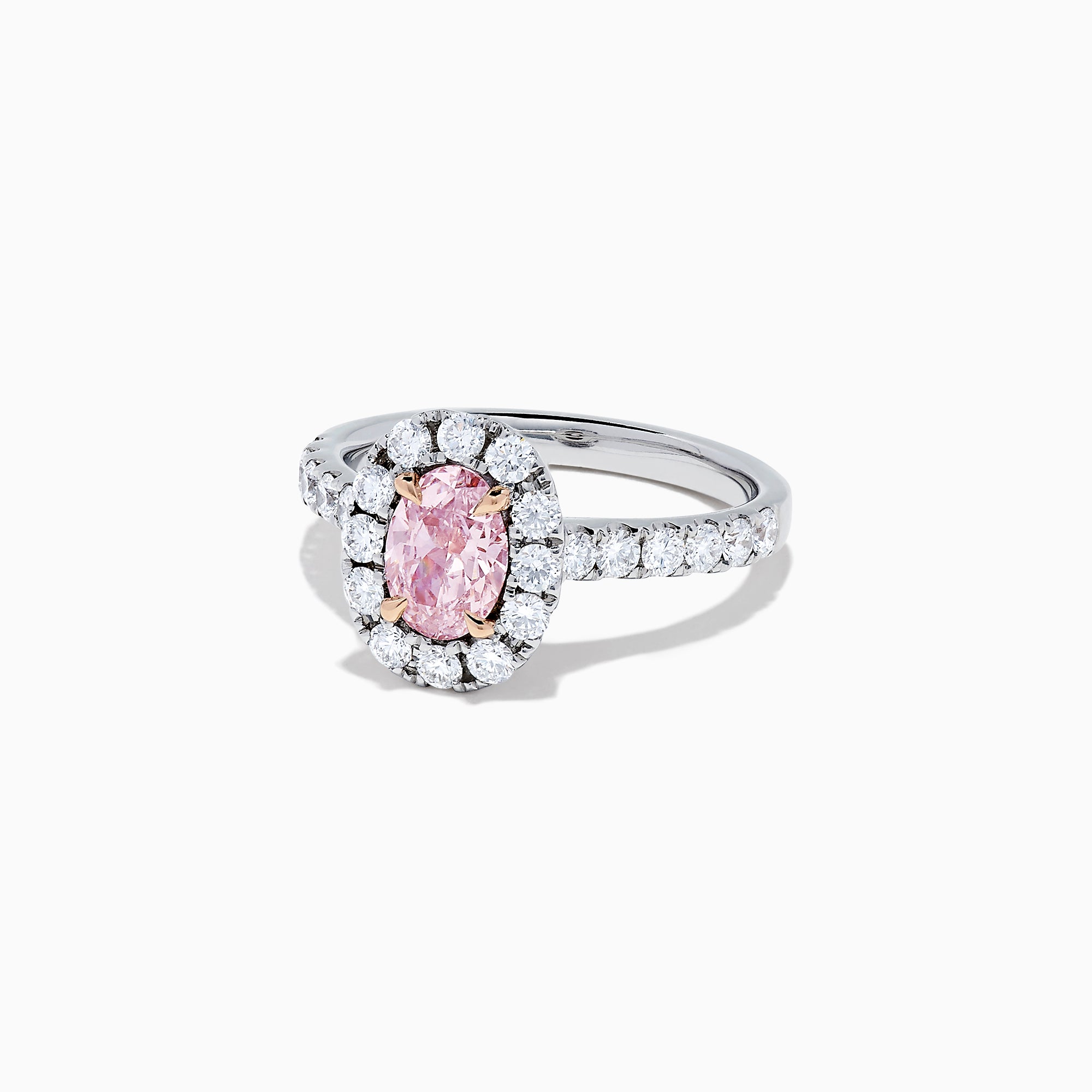 A GIA certified faint pink diamond ring, 1.53 TCW, set in a halo of round white diamonds on an 18K two tone gold band. Shown on a plain white background.