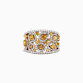 A 14K yellow gold ring with yellow and white diamonds, totaling 2.50 TCW, showcases irregular yellow stones and small white diamonds in an openwork design, displayed against a white background.