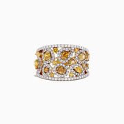 A 14K yellow gold ring with yellow and white diamonds, totaling 2.50 TCW, showcases irregular yellow stones and small white diamonds in an openwork design, displayed against a white background.