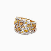 A 14K yellow gold ring with yellow and white diamonds, totaling 2.50 TCW, showcases irregular yellow stones and small white diamonds in an openwork design, displayed against a white background.