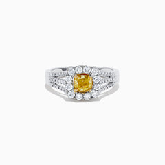 The 14K Two Tone Gold Yellow and White Diamond Ring features a cushion-cut yellow center stone, white diamond halo, split shank band, and a total weight of 1.22 TCW.